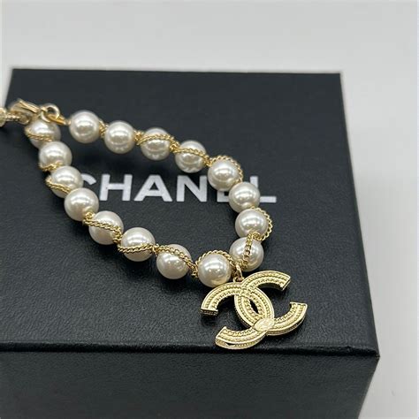 chanel bralette|chanel pearl bracelet with logo.